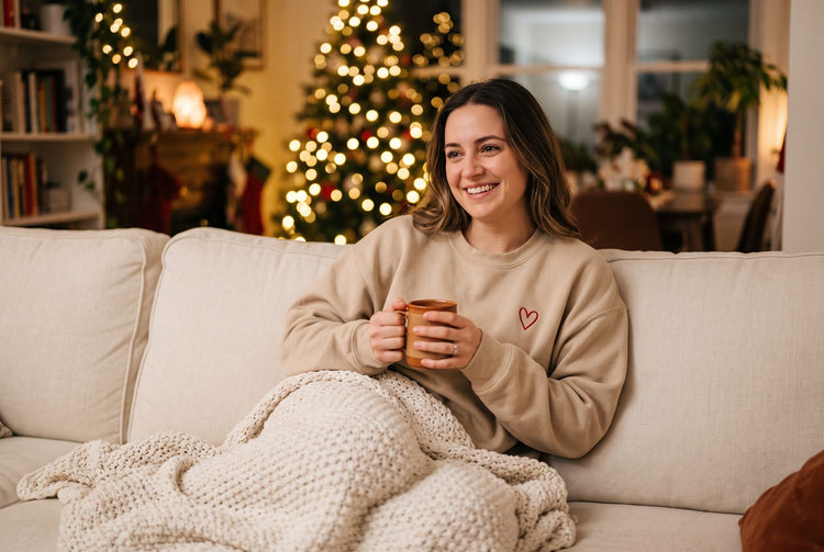 Woman relaxing on the sofa in a cozy custom sweatshirt at Christmas
